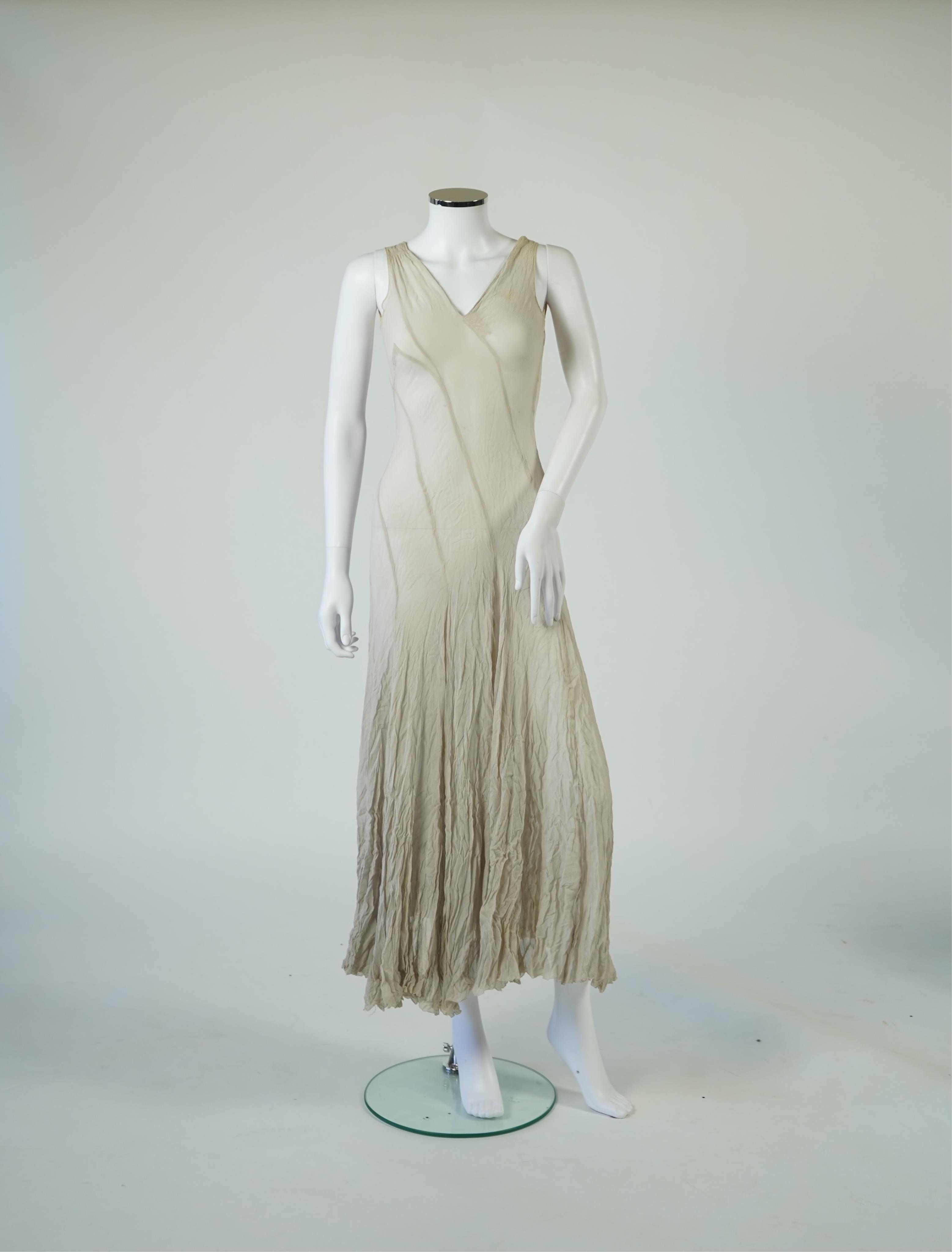 A 1930's grey chiffon bias cut ladies evening dress. 120cm long. Condition - has a small hole at the back and a light mark possibly removed with washing.